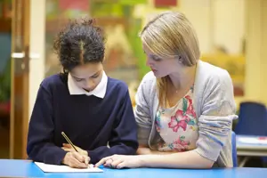 Teacher providing guidance to pupil ?? title